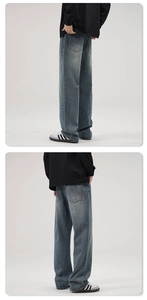 Detail of vintage washed heavy denim straight leg jeans showing back pocket and loose fit
