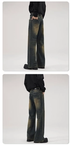 Macro shot of retro distressed wash texture and stitching on wide-leg flared jeans