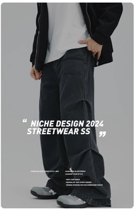 Detail of men's black wide-leg washed denim jeans with a vintage faded street style