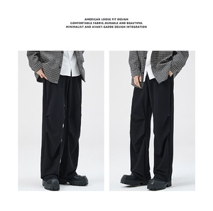 Detail of American loose fit trousers featuring 3D pleated knees and relaxed silhouette