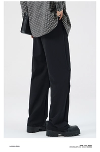 Minimalist black wide-leg trousers side view profile with elegant drape and high texture