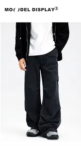 Detail of loose fit dark grey men's cargo denim jeans with vintage washed texture