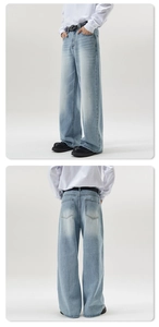 Detail view of light blue wide-leg jeans with vintage washed effect and straight cut