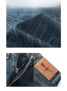 Dettagli dei jeans vintage con zip metallica, tessuto robusto e toppa in pelle impressa