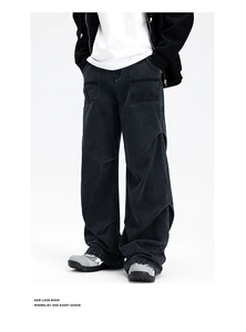 Detail view of black wide-leg parachute jeans featuring contrast stitching and washed denim