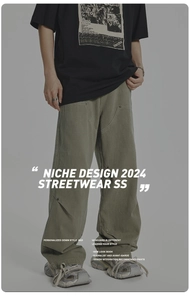Detail of rivet splicing and deconstructed stitching on wide-leg streetwear trousers