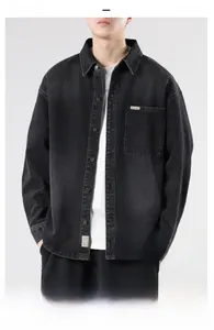 Detail of a vintage black washed denim jacket with metal buttons and a chest pocket