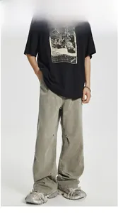 Detail of cargo pants showing contrast stitching and metal rivet construction in sage green