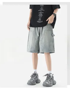 Detail of light gray denim cargo shorts with elastic drawstring waist and side pockets