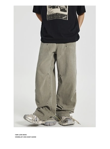 Detail of grey-green oversized carpenter pants with rivets and contrast seam stitching