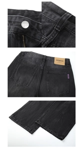 Detail view of denim jeans featuring metal button, zipper fly, and branded leather patch