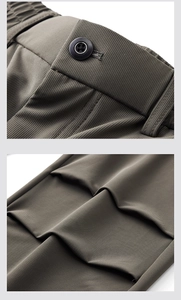 Detailed macro view of olive green casual trousers showing texture and button finish