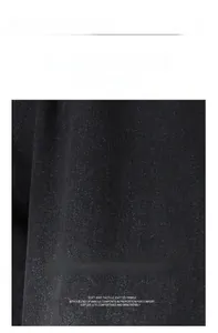 Macro view of soft black cotton denim fabric with visible twill texture and breathable fibers