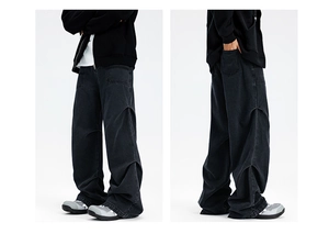 Detail of black wide-leg carpenter jeans with vintage wash and side panelling