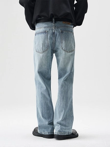 Men's light blue vintage washed bootcut jeans with a straight fit and leather back patch