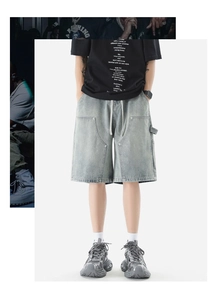 Detail of light blue denim cargo shorts featuring carpenter loops and utility pockets