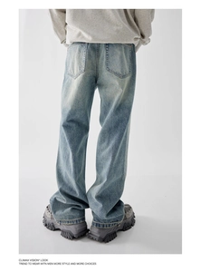 Detail of vintage washed denim jeans with back pockets and chunky platform sneakers