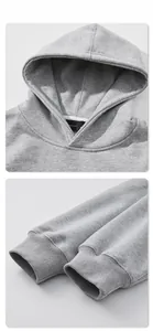Detail of grey hoodie showing rib-knit cuffs and internal neck label craftsmanship