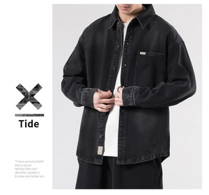Detail of vintage washed black denim shirt featuring chest pocket and woven label