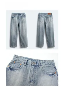 Detail view of washed denim jeans showing orange stitching and brown leather waist patch