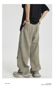 Detail of gray-green loose-fit cargo pants showing wide-leg cut and vintage washed fabric