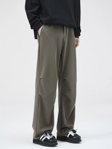 Olive green pleated straight-leg trousers with draped fabric and knee pleat design