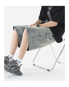 Detail view of denim cargo shorts showing retro wash texture and side pocket stitching