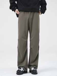 Men's olive pleated straight wide-leg trousers with a stylish draped silhouette
