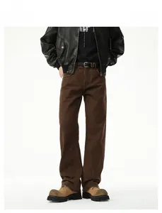 Detail of vintage brown straight-leg cotton jeans featuring rugged texture and loose fit