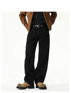 Detail view of black wide-leg trousers with a fine belt and structured fabric for men