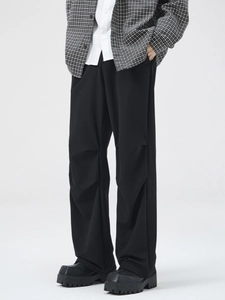 Men's minimalist black wide-leg trousers with unique knee pleated layering detail