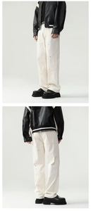 Detail of off-white wide-leg cotton jeans featuring paint splatter and distressed rip effects
