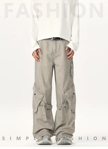 Detailed view of multi-pocket cargo pants with knee strap adjustment and metal ring accents