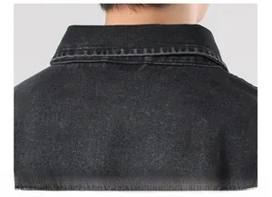 Detail view of the vintage black denim jacket showing collar texture and washed fabric