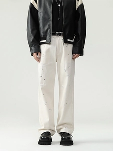 Men's off-white cotton straight-leg pants with distressed details and paint splatter