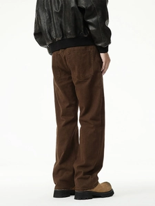 Vintage brown straight-leg cotton jeans with whiskers paired with a retro leather jacket