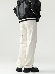 Men's off-white cotton straight jeans with black ink splash design and distressed details