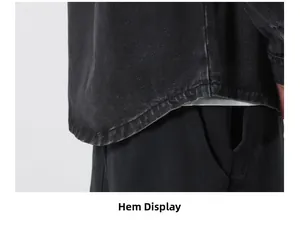 Close-up of curved hem and washed texture on black denim jacket for men and women