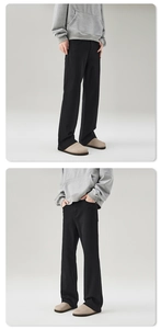 Detailed view of black straight-leg flare jeans showing premium drape and relaxed fit