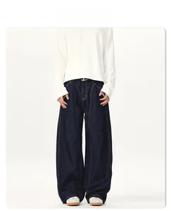 Detail showing loose fit wide leg indigo denim pants with vertical stitching seams