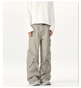 Detail view of cargo pants with large 3D pockets and adjustable tactical straps