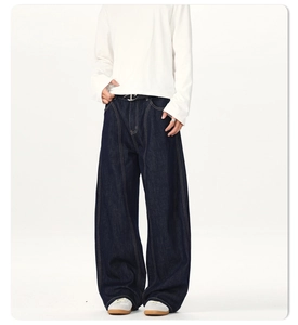 Detail of dark blue high-waisted wide leg denim pants with contrast yellow stitching