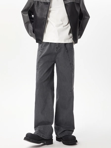 Detail view of multi-pocket washed black cargo pants with a relaxed wide-leg fit
