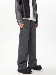 Detail view of charcoal grey cargo pants with side pockets and casual wide-leg fit
