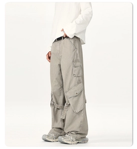 Detail of light gray tactical cargo pants with 3D flap pockets and drawstring hem