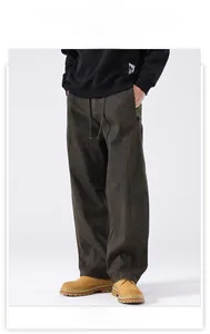 Detail view of heavy-duty double-knee carpenter pants in deep olive with drawstring waist
