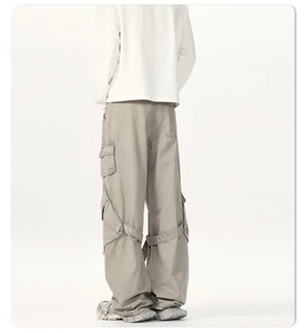 Detail of cargo pants with functional straps and flap pockets on the back of the knees