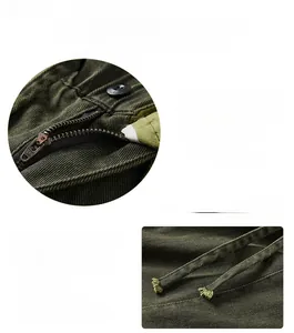 Detail of army green cargo pants featuring a metal button, zipper fly, and drawstring waist