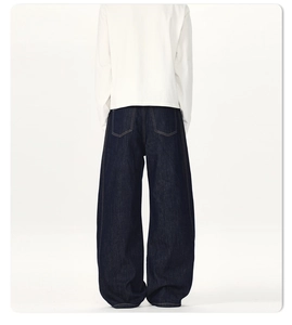 Detailed back view of wide-leg dark indigo denim pants with contrast stitching details