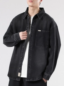 Men's oversized black denim jacket with vintage wash and minimalist chest pockets